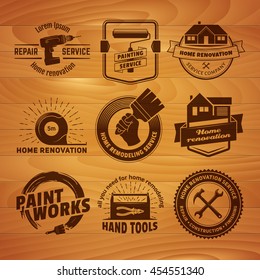 House remodeling logos. Vector labels for home renovation services. Set of vintage badges with hand tools and equipment on a wooden background