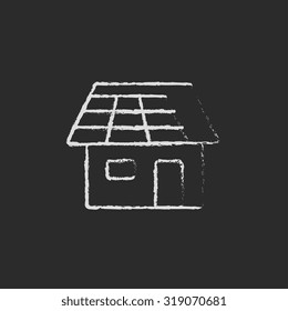 House with solar panel hand drawn in chalk on a blackboard vector white icon isolated on a black background.