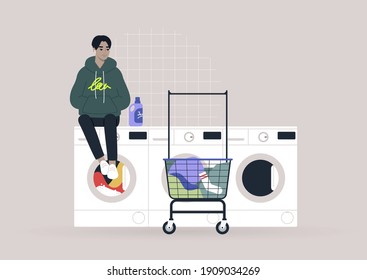 Household chores concept, a young male Asian character waiting for their laundry in a coin laundromat