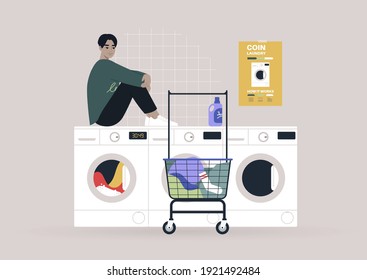 Household chores concept, a young male Asian character waiting for their laundry in a coin laundromat