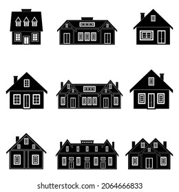 Houses of different houses and different sizes are black on a white background. Vector image.