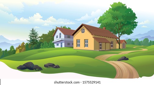 Houses in Europe with green meadows, dirt road and a vast landscape of mountains 