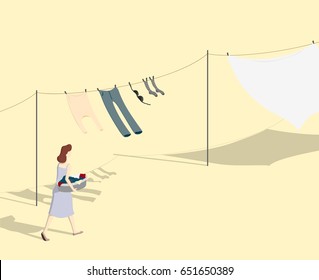 Housewife hanging clothes to dry on clothes-line on a sunny day.