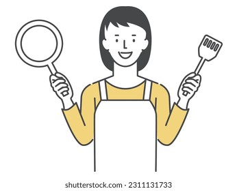 A housewife holding a frying pan and a frying pan in both hands
