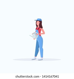 Housewife holding watering can. Young woman gardener.  Smiling girl in uniform doing housework concept.  Female cartoon character, full length flat.