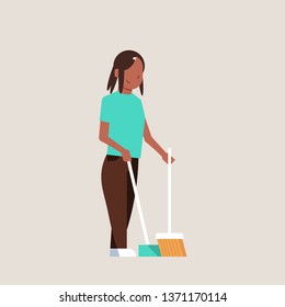 housewife sweeping floor with broom and scoop african american girl doing housework house cleaning concept female cartoon character full length flat gray background