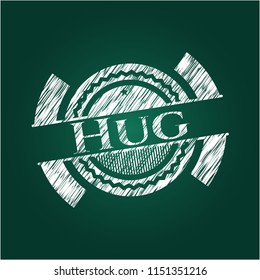 Hug chalkboard emblem written on a blackboard