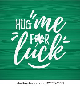 Hug Me For Luck handdrawn dry brush style lettering on green wooden background, 17 March St. Patrick's Day celebration. Suitable for t-shirt, poster, etc., vector illustration