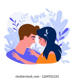 Hugging couple on the natural background with big leaves