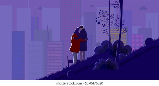 A hugging couple stands against the night lights of the city