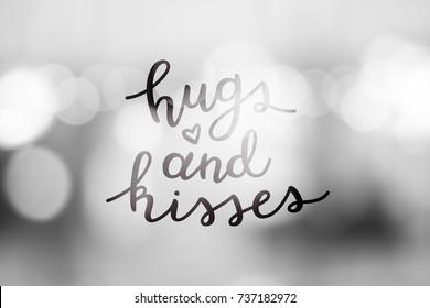 hugs and kisses, lettering, vector handwritten text on blurred lights