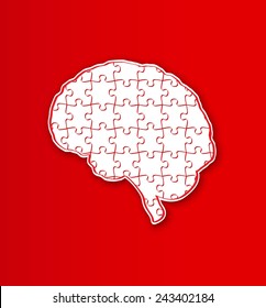 human brain created from puzzle pieces on red background