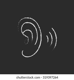 Human ear hand drawn in chalk on a blackboard vector white icon isolated on a black background.