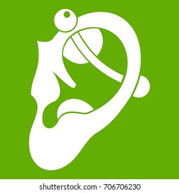 Human ear with piercing icon white isolated on green background. Vector illustration