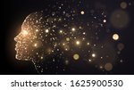 Human face on a dark background of gold glowing particles