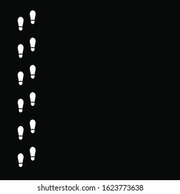 Human footprints icon isolated on black background. Vector art.