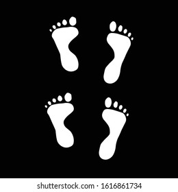 Human footprints isolated on a black background