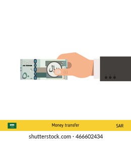 Human hand gives money vector illustration. Saudi Arabian riyal banknote.