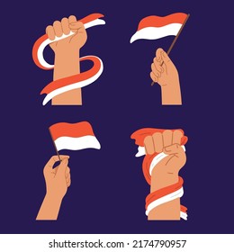 Human Hand Hold Waving Flag of Indonesia Independent
