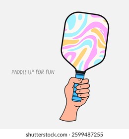 Human hand holding a colorful pickleball paddle with the phrase Paddle up for fun, symbolizing excitement, sports, and active lifestyle