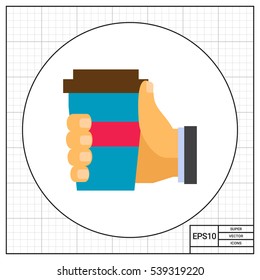 Human hand holding disposable cup