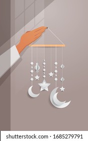human hand holding eastern traditional baby mobile with moons stars and lantern eid mubarak ramadan kareem muslim religion holy month flat vertical vector illustration