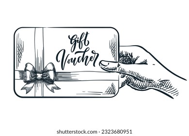 Human hand holding gift voucher card. Discount coupon concept. Vector hand drawn sketch illustration of certificate with bow ribbon. Banner, poster design element with calligraphy lettering