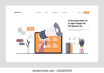human hand holding loudspeaker on laptop screen announcement digital marketing concept