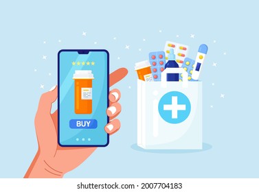Human hand holding mobile phone for medicine online payment. Home delivery pharmacy service. Paper bag with pills bottle, medicines, drugs, thermometer inside. Medical assistance, health care concept