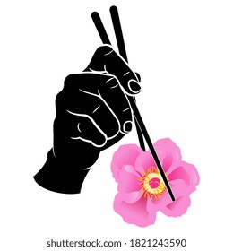 Human hand holding pink peony flower with chopsticks. Creative funny concept for vegan and vegetarian healthy food.