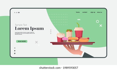 human hand holding plate with burger hot dog cola and cupcake junk unhealthy fast food concept horizontal copy space