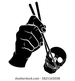 Human hand holding human skull with chopsticks. Creative concept. Black and white silhouette.