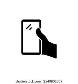 Mano humana que sostiene el icono plano sólido del Vector del smartphone aislado en el fondo blanco.