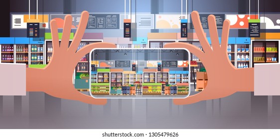 human hand holding smartphone taking photo modern supermarket interior with grocery food assortment displaying on mobile phone screen flat horizontal