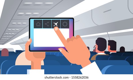 human hand holding tablet pc with flight mode rules of airplane safety concept modern plane board with passengers horizontal flat vector illustration