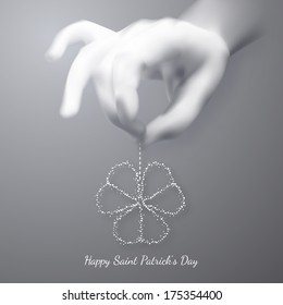 Human hand holding three leafed shamrock. St. Patrick's day card.  Vector illustration. EPS10.