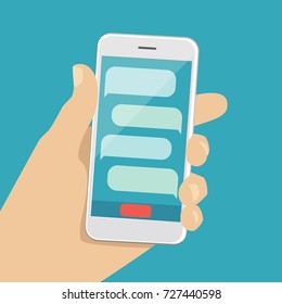 A human hand holds a smartphone with text balloon on screen. Vector illustration of a smartphone with chat in a man hand. Modern phone in the palm of your hand. Infographics for flat design