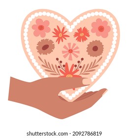 Una mano humana sostiene una tarjeta de San Valentín en forma de corazón, con un patrón floral. Un símbolo de amor, romance, gratitud. Día de San Valentín de Boho. Ilustración del vector de color aislada en un fondo blanco