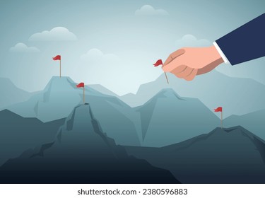 Mano humana insertando una bandera en la parte superior de la montaña.Finalización de tarea. Hacer un plan.Ocupar el mercado.Tomar la cuota de mercado.