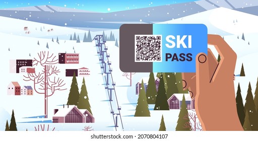 human hand using ski pass application on smartphone screen winter vacation concept snowy mountains landscape