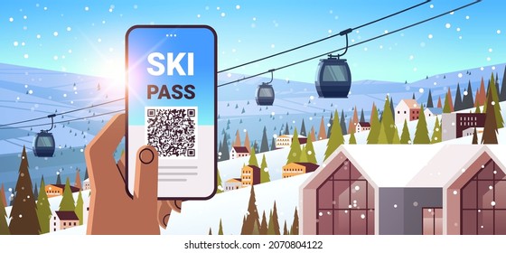 human hand using ski pass application on smartphone screen winter vacation concept snowy mountains landscape