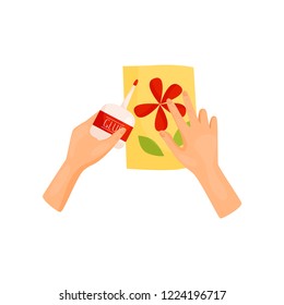 Human hands glue colored paper details of applique. Handmade craft. DIY postcard. Hobby theme. Flat vector icon