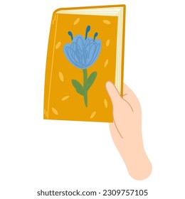 Human hands hold closed book with flowers.Read books lover. Education, literacy, book day. Relaxing time to reading.