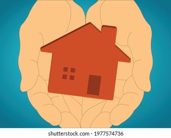 Human hands holding a house 