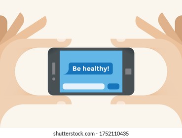 Human hands holding mobile phone with "Be healhy!" SMS message on screen. Concepts: healthy lifestyle, healthcare, vegetarianism, diet and nutrition, immunity, coronavirus COVID-19 pandemic outbreak.