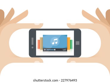 Human hands holding mobile phone with music player on the screen.  Idea - Mobile collection of audio, Cloud computing technologies for internet music listening.