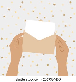 Human hands are holding an open envelope with a letter. Mail letter reading concept. Greeting card.