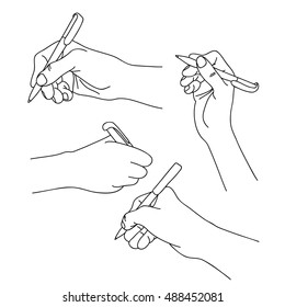 Human Hands Holding A Pen And Writing On Paper.