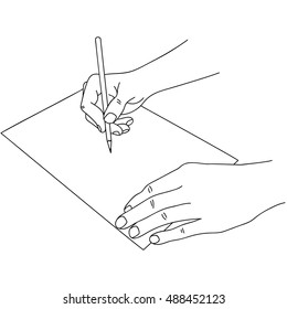 Human hands holding a pen and writing on paper.