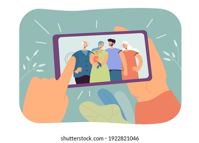 Human hands holding smartphone with family selfie isolated flat vector illustration. Cartoon photo of mom, dad, grandparents and kid making dinner in aprons. Memories and smart technologies concept
